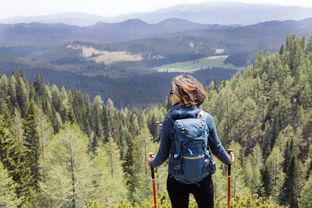 View at young woman hiking in mountainの写真素材