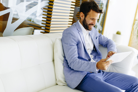 Businessman using tablet computer  in modern officeの写真素材
