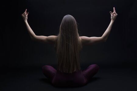 Young woman practicing yoga in the studio