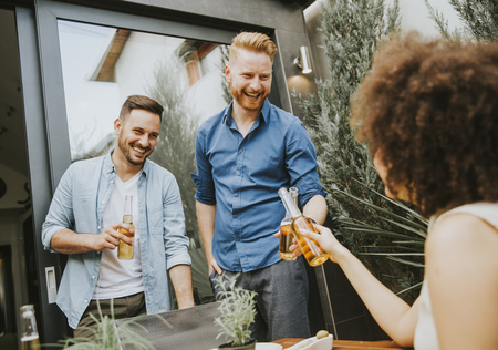 Group of happy young people having fun in the backyardの写真素材