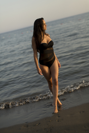 Pretty young woman in bikini at beach on a summer dayの写真素材