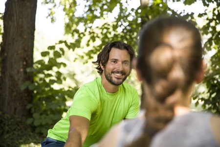 Young couple having exercise in the park on a sunny dayの写真素材