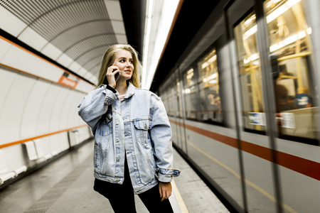 Young woman waiting train in undergroundの写真素材