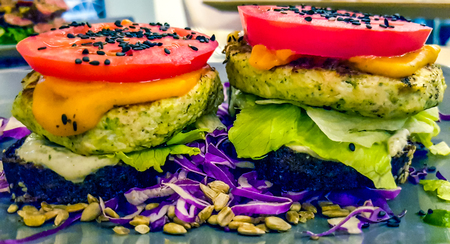 Close up view at vegetarian burgers garnished with vegetablesの写真素材