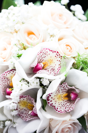 Close up view at bouquet of white orchids and rosesの写真素材