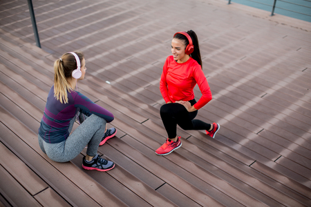 View at two young women exercise outsideの写真素材