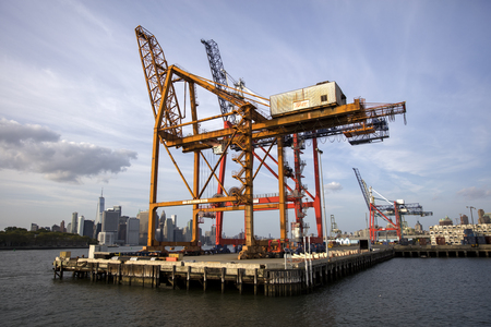 NEW YORK, USA - AUGUST 28, 2017: View at cranes in Red Hook Container Terminal in New York. The container terminal was built in the 1980s and have 6 active container cranes.のeditorial素材
