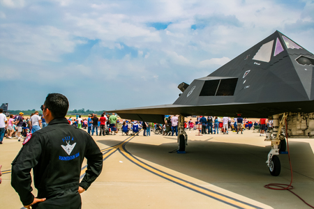 BARKSDALE, USA - APRIL 22, 2017: Unidentified man by Lockheed F-117 Nighthawk at Barksdale Air Base. Since 1933, the base has been inviting the public to view aircrafts at the annual airshow.のeditorial素材