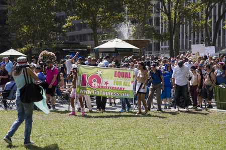 NEW YORK, USA - AUGUST 26, 2017: Unindentified people at Annual GoTopless Day Parade in Bryant Park, New York City. Parade is done in the name of equal topless laws.のeditorial素材