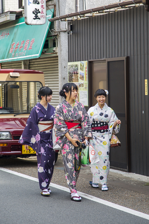 KYOTO, JAPAN - OCTOBER 7, 2016: Unidentified women in traditional clothes near Fushimi Inari shrine in Kyoto, Japan. This popular shrine have 32,000 sub-shrines  throughout Japanのeditorial素材