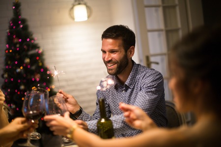 Group of young people celebrating New Year and drinking red wineの写真素材