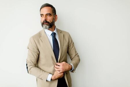 Portrait of bearded businessman by wallの写真素材