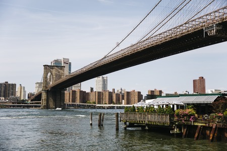 NEW YORK, USA - AUGUST 27, 2017: View at Brooklyn Bridge in New York. It was opened at 1883 and is one of the oldest roadway bridges in the US.のeditorial素材