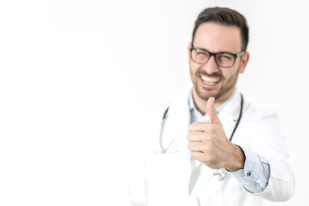 Handsome young doctor with glasses gesture with thumb upの写真素材