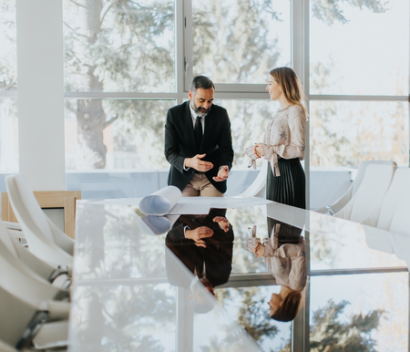 Business couple analyzing project in modern officeの写真素材
