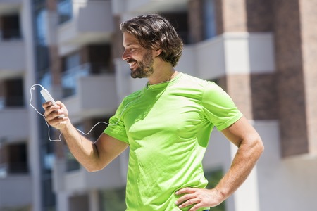 Portrait of male runner using mobile phone outdoor