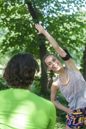 Young couple having training in the park on a sunny dayの写真素材