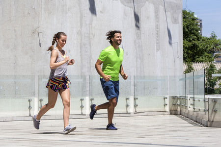 Couple running in urban enviroment  at hot summer dayの写真素材