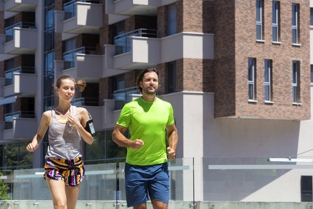 Couple running in urban enviroment  at hot summer dayの写真素材