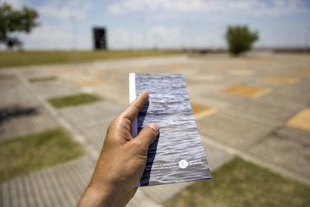 BUENOS AIRES, ARGENTINA - JANUARY 22, 2018: Male hand with ticket of Remembrance park in Buenos Aires, Argentina. It is an open air museum dedicaed to the victims of the 197683 military regime.のeditorial素材