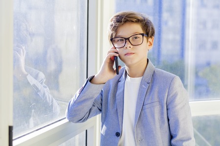 Portrait of teen boy with mobile phoneの写真素材