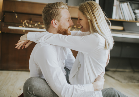 Happy and loving couple kissing in the roomの写真素材