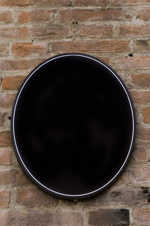 Empty oval sign with copy space on the old brick wallの写真素材