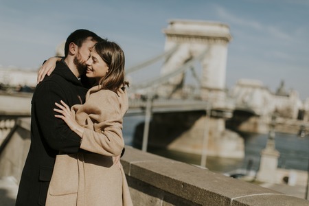Young happy attractive couple in love hugging at the background of the magnificent landscape view of Budapest, Hungaryの写真素材