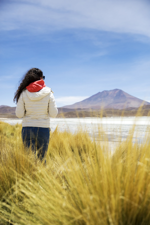 Young woman at Laguna Hedionda at Eduardo Avaroa Andean Fauna National Reserve in Boliviaの写真素材