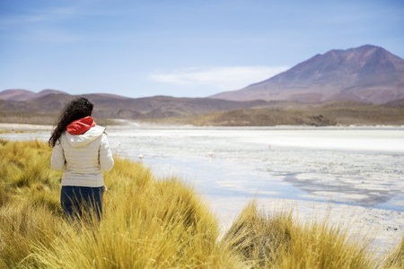 Young woman at Laguna Hedionda at Eduardo Avaroa Andean Fauna National Reserve in Boliviaの写真素材