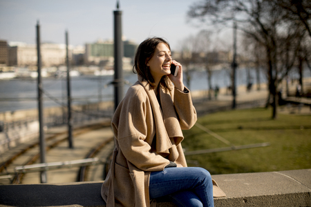 Woman talking on the mobile phone in the parkの写真素材