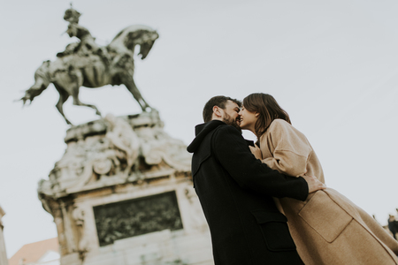 Loving couple outdoor with monument in background in Budapest, Hungaryの写真素材