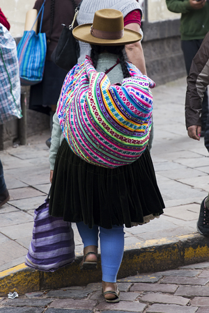 CUSCO, PERU - JANUARY 5, 2018: Unidentified woman on the street of Cusco, Peru. the Entire city of Cusco was designated a UNESCO World Heritage Site in 1983.のeditorial素材