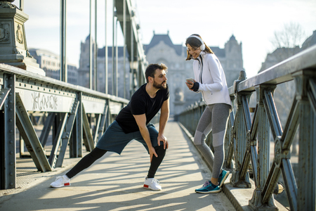 Young handsome couple have training in urban enviroment at sunny dayの写真素材