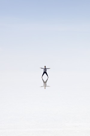 Young man in  at Salar de uyuni salt flat in Bolivia