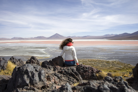 Young woman at Laguna Colorada at Eduardo Avaroa Andean Fauna National Reserve in Boliviaの写真素材