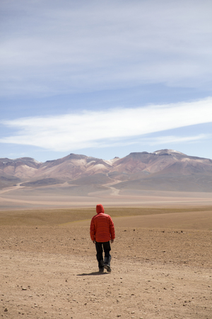Young man at Dali desert at Eduardo Avaroa Andean Fauna National Reserve in Boliviaの写真素材