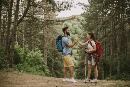 Active youngcouple hikers taking rest in mountainの写真素材