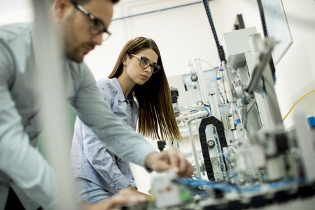 Portrait of young couple of students working at robotics labの写真素材