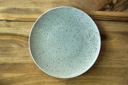 Top view with copy space empty plate on concrete wooden backgroundの写真素材