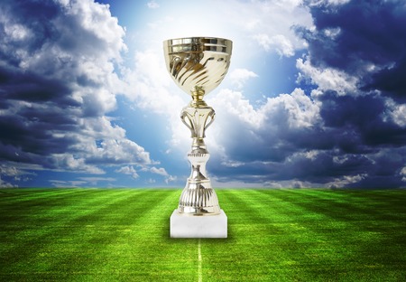 Trophy on the football field isolated on the white backgroundの写真素材