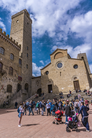 SAN GIMIGNANO, ITALY - APRIL 8, 2018: Unidentified people on Piazza del Duomo at San Gimignano, Italy. Historic Centre of San Gimignano is designated as UNESCO World Heritage Site since 1990.のeditorial素材