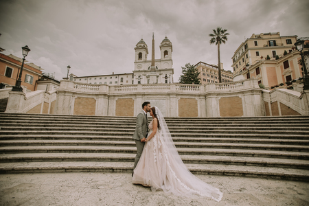Young wedding couple on Spanish stairs in Rome, Italyの写真素材