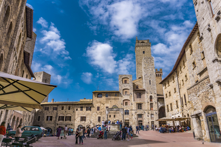 SAN GIMIGNANO, ITALY - APRIL 8, 2018: Unidentified people at Piazza della Cisterna in San Gimignano, Italy. Historic Centre of San Gimignano is designated as UNESCO World Heritage Site since 1990.のeditorial素材