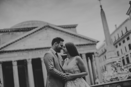 Young attractive newly married couple  posing in Rome with beautiful and ancient architecture in the backgroundの写真素材