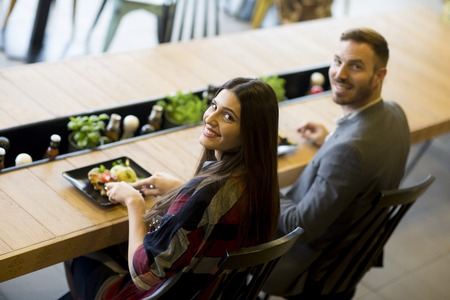 Young loving couple having lunch in the modern restaurantの写真素材
