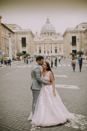 Lovely young wedding couple by Saint Peter cathedral in Vaticanの写真素材