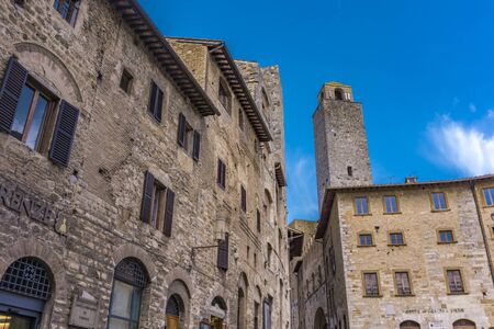 SAN GIMIGNANO, ITALY - APRIL 8, 2018: Old street of San Gimignano, Italy. Historic Centre of San Gimignano is designated as UNESCO World Heritage Site since 1990.のeditorial素材