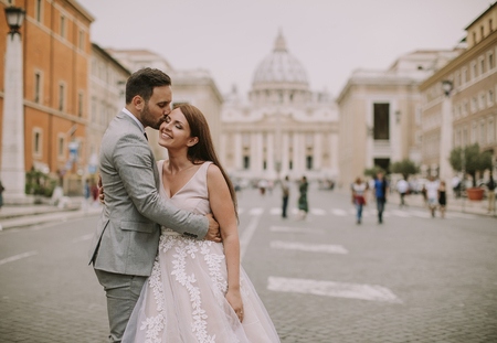 Lovely young wedding couple by Saint Peter cathedral in Vaticanの写真素材