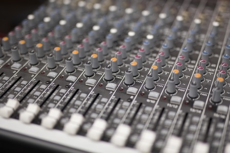 Close up view at mixing console in studio